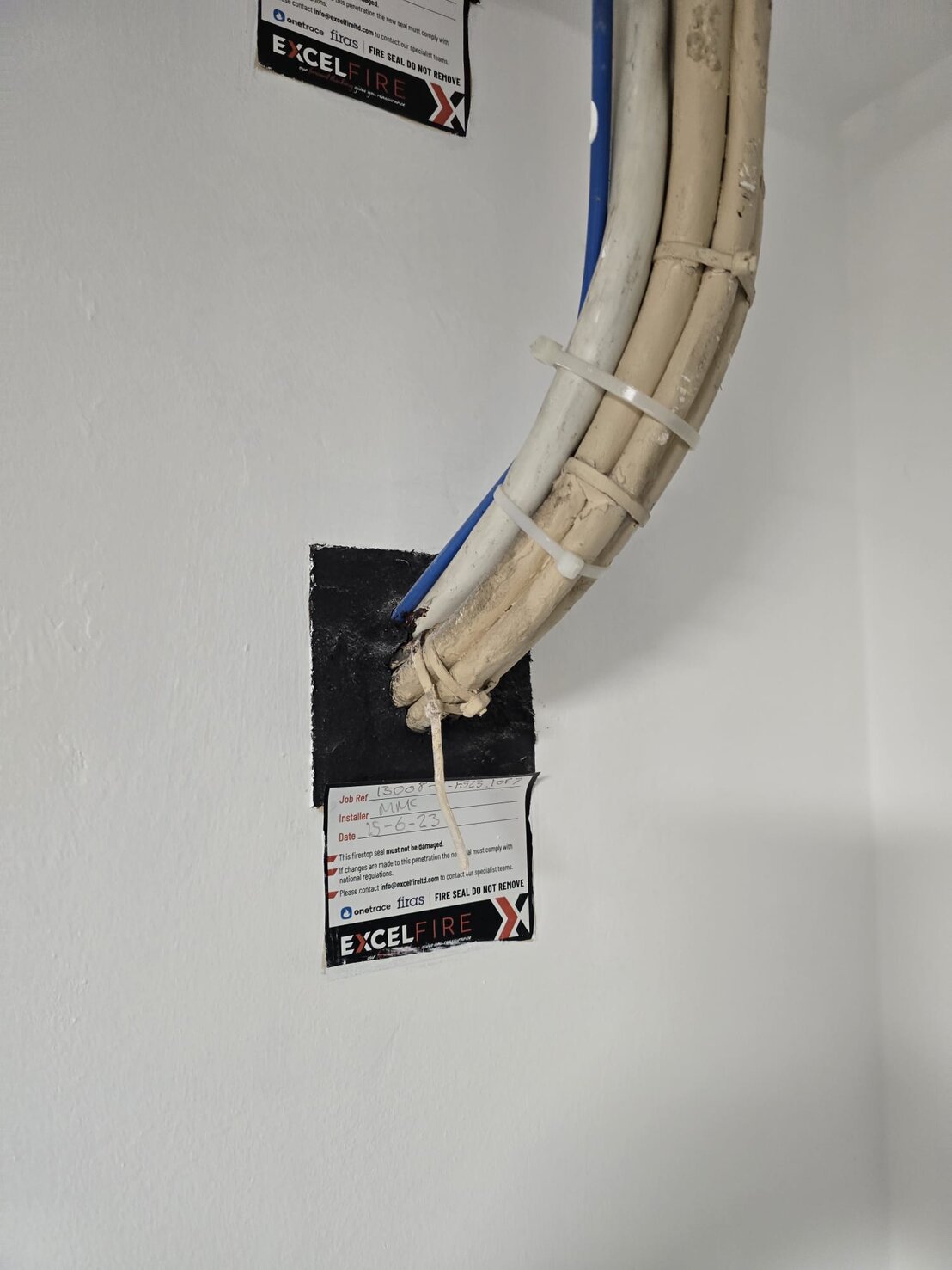 Fire stopping applied around cable trays and conduits